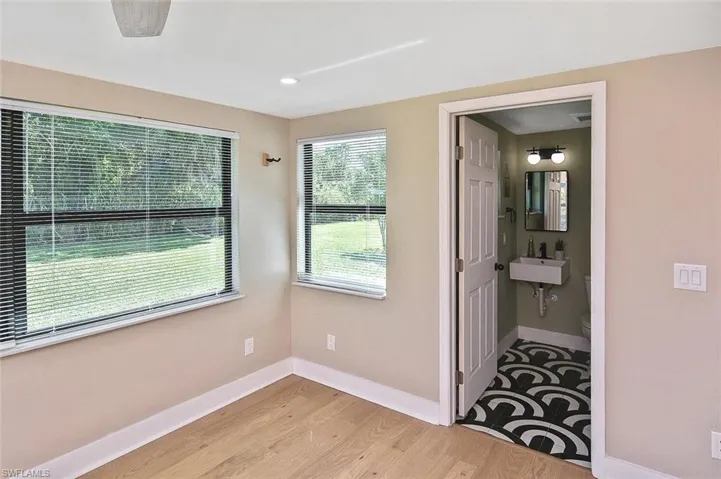 Ensuite bathroom has the same Art Deco-inspired floor tile with an artistic flair!