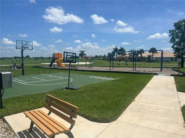 View of basketball court with a yard