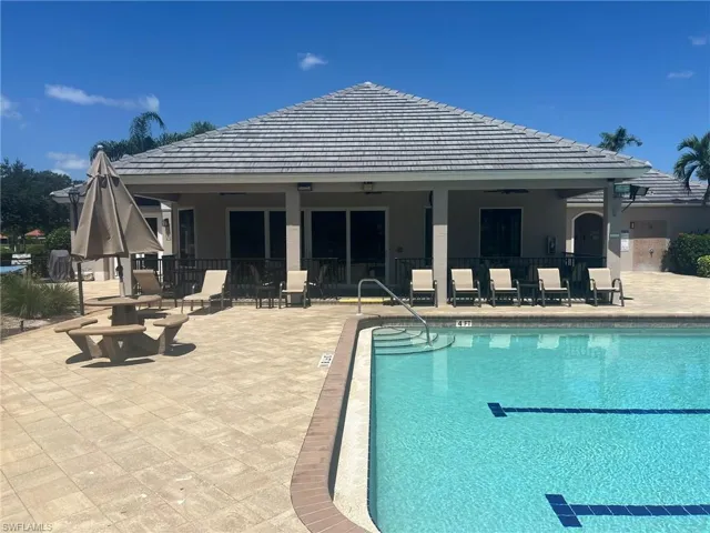 Community pool featuring a patio