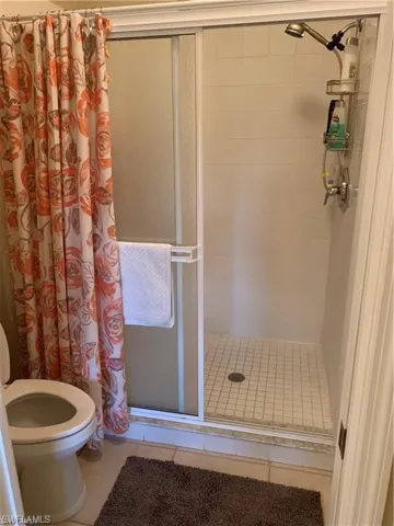 Bathroom featuring a stall shower and tile patterned flooring