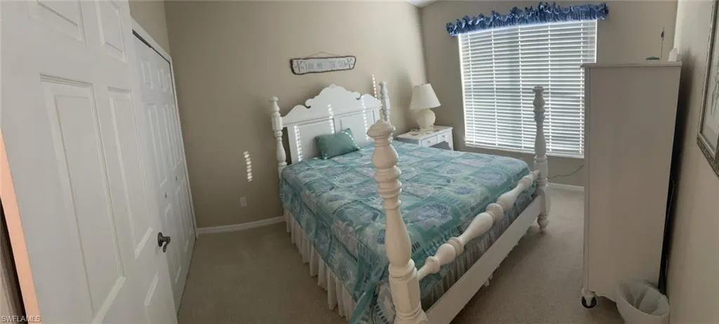 Guest bedroom with a closet and carpet floors