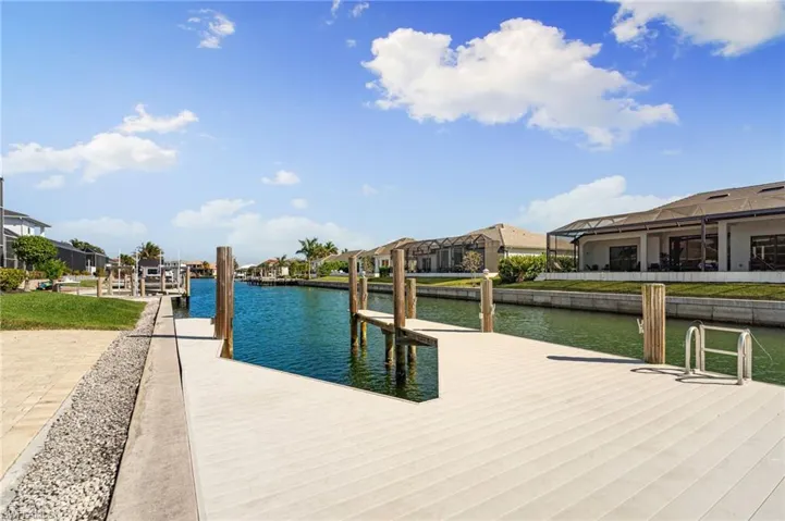 Dock with a water view and a residential view