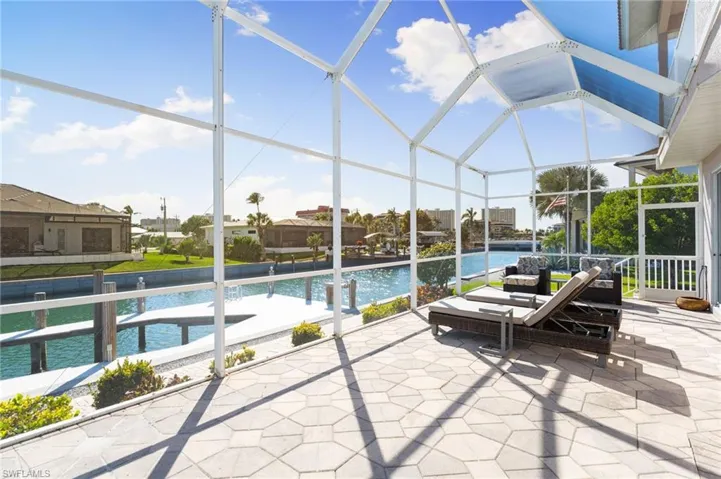 View of patio featuring a sunroom, a lanai, and an outdoor pool