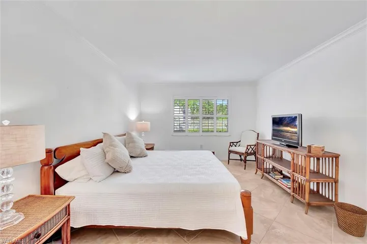 Tiled bedroom with ornamental molding
