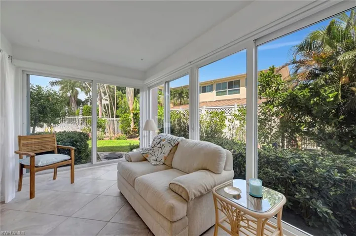 Sunroom / solarium with healthy amount of natural light and tile patterned floors