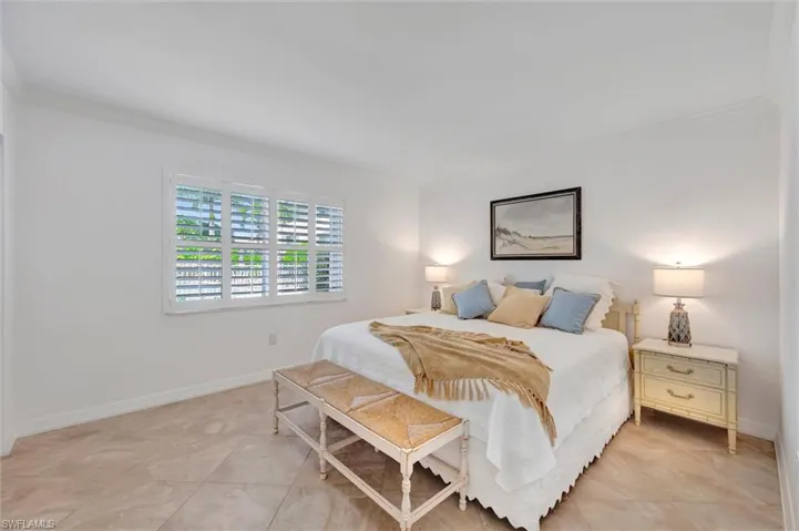 Bedroom featuring ornamental molding and light tile patterned floors