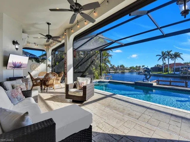 View of patio with a lanai, a water view, and an outdoor hangout area