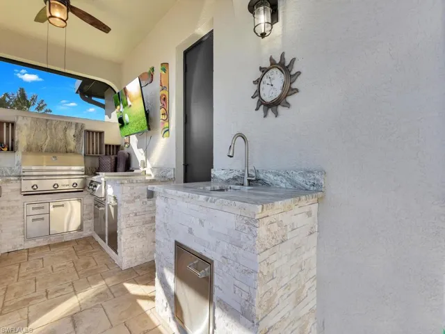 View of patio / terrace with area for grilling, ceiling fan, and sink