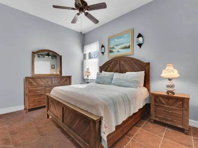 Tiled bedroom with ceiling fan
