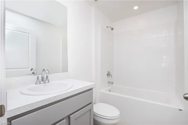 Full bathroom with vanity, toilet, and bathing tub / shower combination