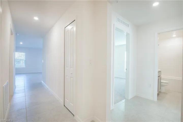 Hallway featuring light tile patterned floors