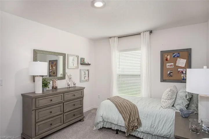Bedroom with light carpet