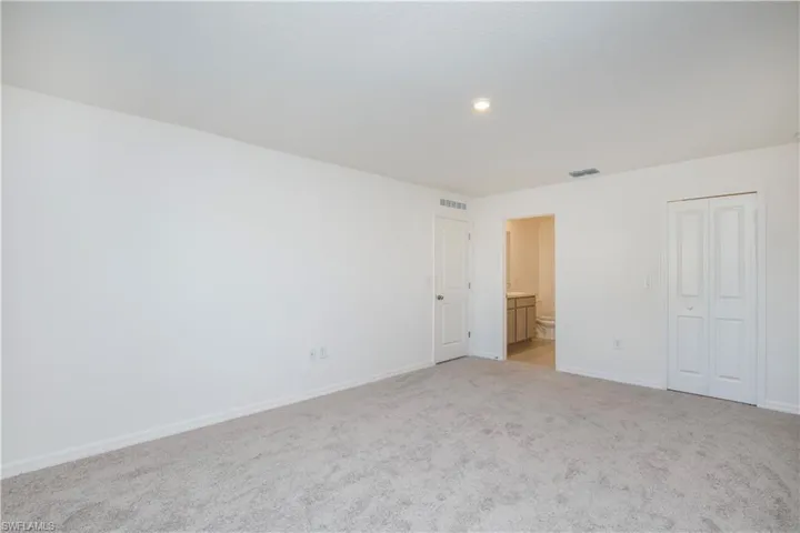 Spare room featuring light carpet