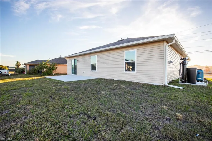 Rear view of property with a patio area and a lawn