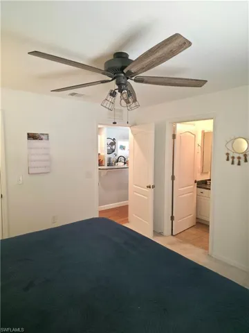 Unfurnished bedroom with ceiling fan and ensuite bath