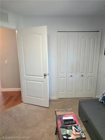 Carpeted bedroom featuring baseboards and a closet