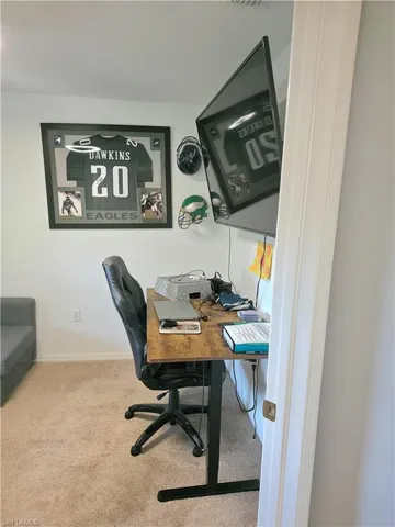 Carpeted home office with baseboards