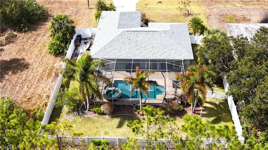 Aerial view of property and surrounding area featuring a pool area