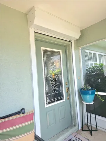 Property entrance with stucco siding