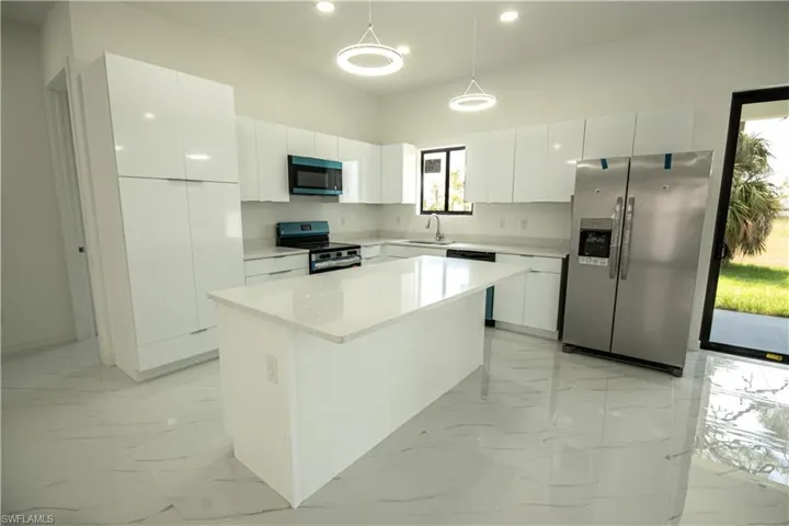 Kitchen featuring stainless steel appliances, recessed lighting, a sink, and marble finish floor