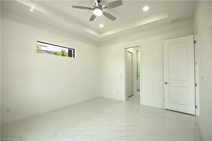 Empty room with recessed lighting, baseboards, visible vents, and marble finish floor