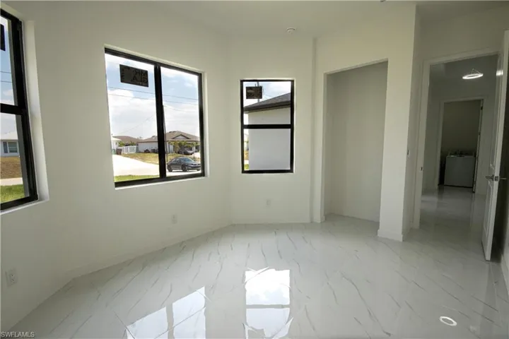 Spare room with washer / clothes dryer, baseboards, and marble finish floor