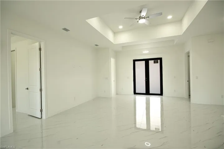 Unfurnished room featuring recessed lighting, ceiling fan, french doors, and marble finish floor