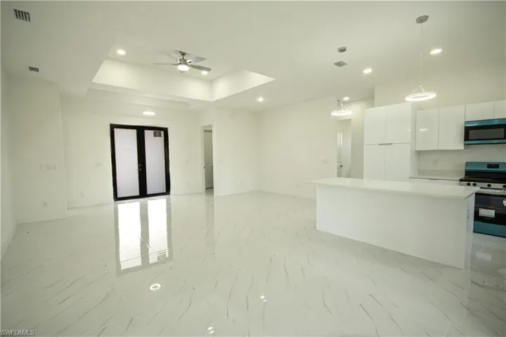 Kitchen featuring visible vents, ceiling fan, recessed lighting, white cabinets, and stainless steel appliances