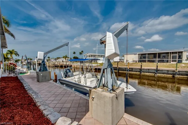 Dock area featuring a water view and boat lift