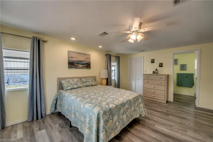 Bedroom featuring wood finished floors, a ceiling fan, recessed lighting, and a closet