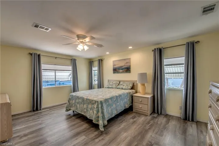 Bedroom featuring wood finished floors, recessed lighting, and a ceiling fan