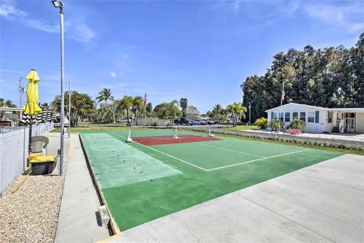 View of property's community with a tennis court