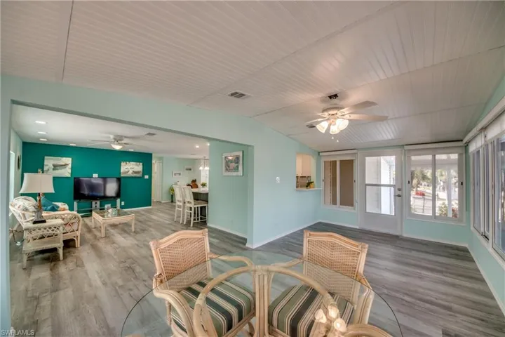 Dining area featuring ceiling fan, wood finished floors, vaulted ceiling, and wood ceiling