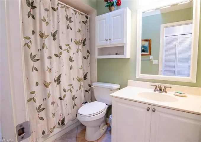 Bathroom with tile patterned flooring, vanity, and toilet