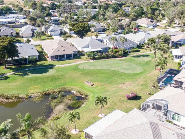 Birds eye view of property with a water view