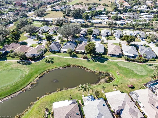Birds eye view of property with a water view