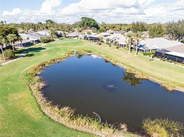 Birds eye view of property with a water view