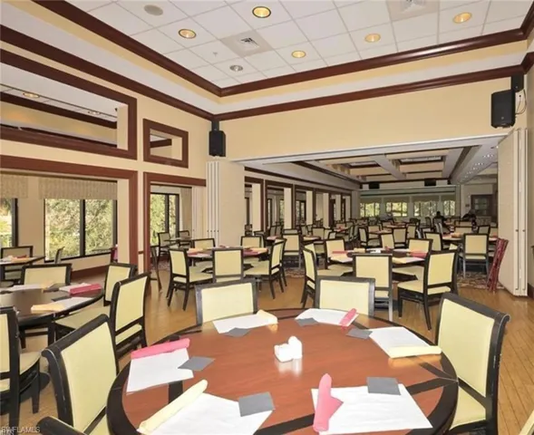 Dining room with hardwood / wood-style flooring and ornamental molding