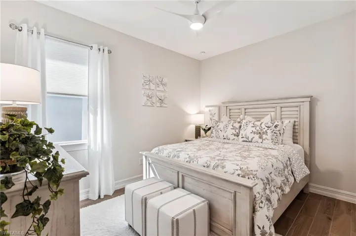 Bedroom with ceiling fan and dark hardwood / wood-style flooring