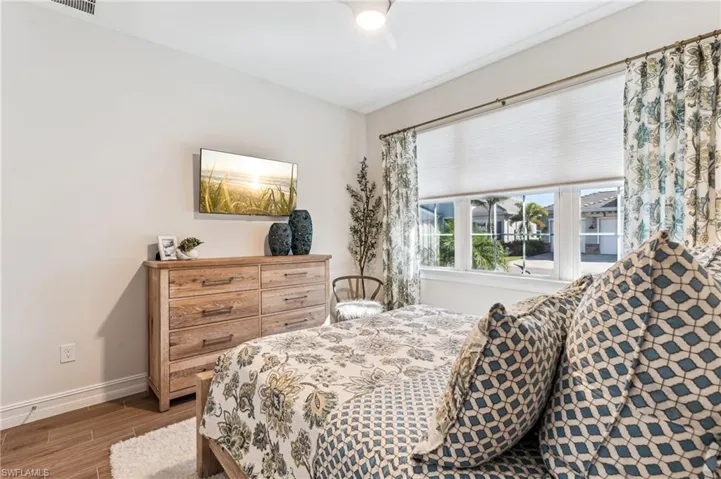 Bedroom with ceiling fan and hardwood / wood-style floors