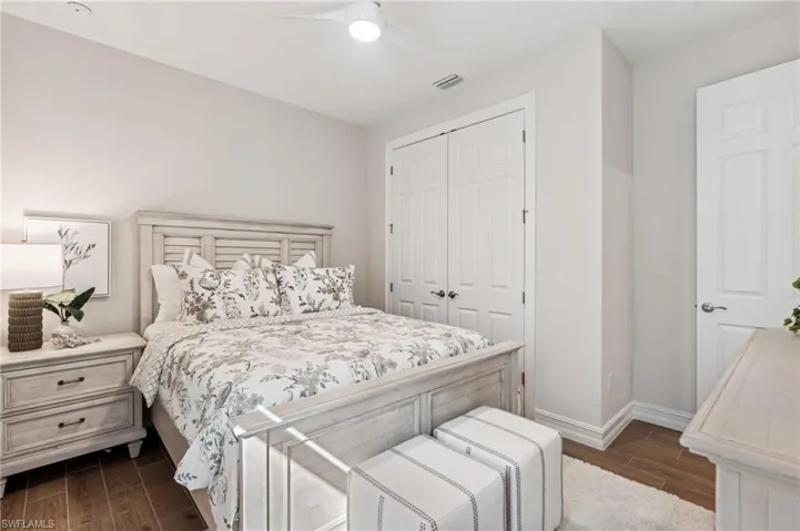 Bedroom featuring a closet, ceiling fan, and dark hardwood / wood-style flooring