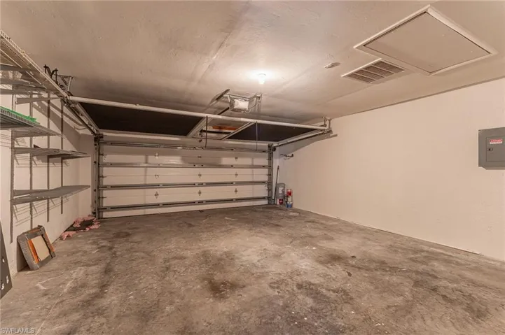 Garage with electric panel and a garage door opener