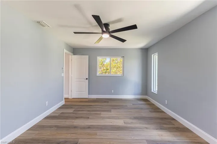 Empty room featuring wood finished floors and ceiling fan