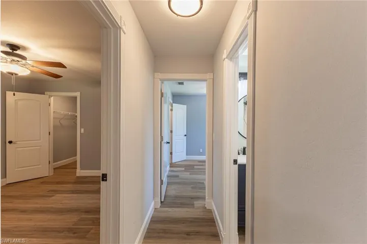 Hall featuring light wood-style flooring and baseboards
