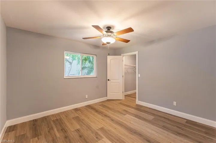 Spare room with wood finished floors and a ceiling fan