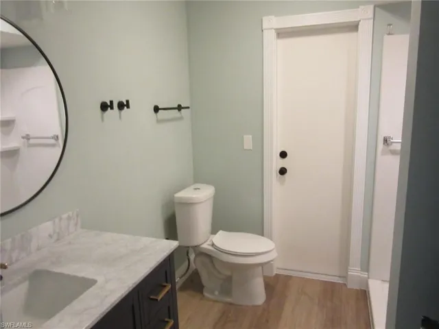 Full bathroom featuring light wood finished floors and vanity