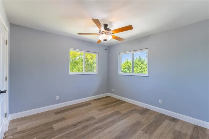 Spare room with wood finished floors and a ceiling fan