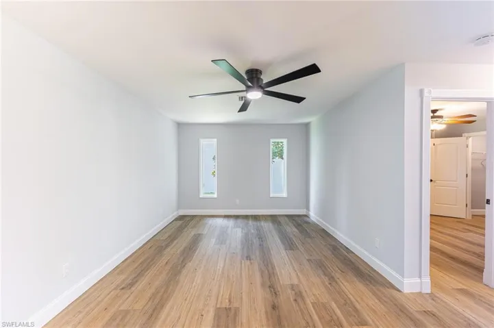 Unfurnished room with light wood-style flooring and ceiling fan