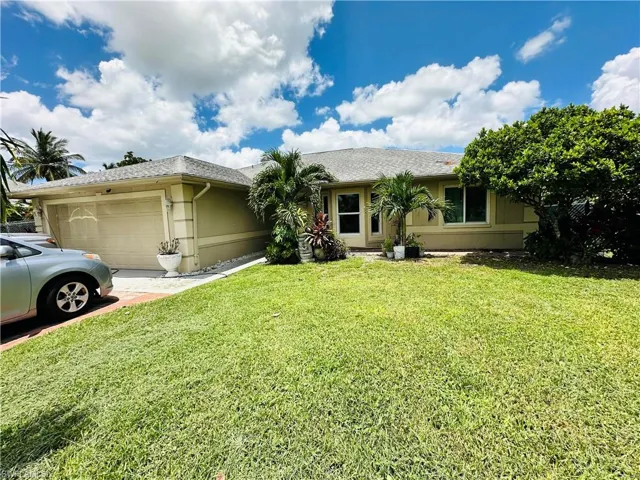 Ranch-style home with a garage and a front yard