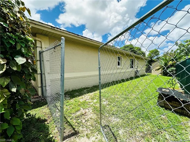 View of side of property featuring a yard